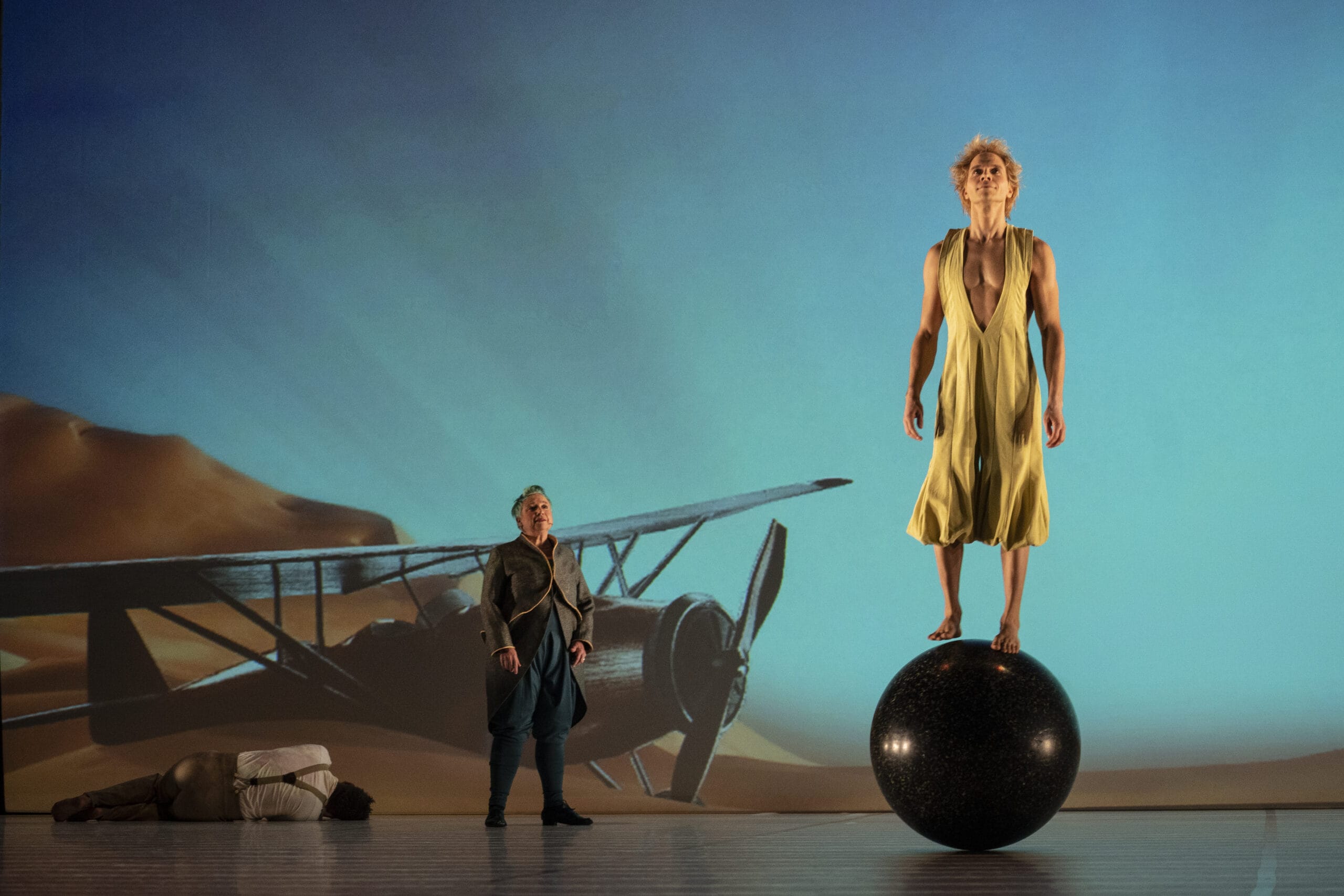 Aurélien Bednarek (lying down), Chris Mouron, and Lionel Zalachas (standing on ball) in <i>The Little Prince</i>. Photo: Joan Marcus